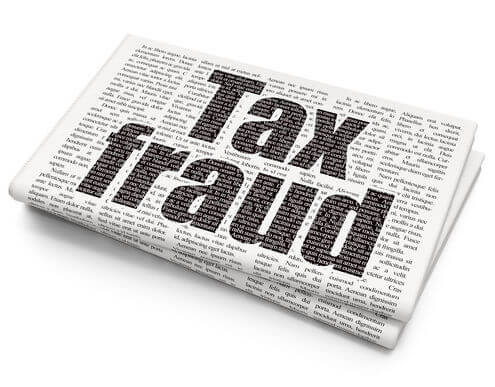 tax fraud written on newspapers
